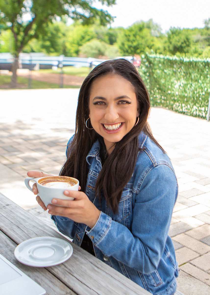 Karen holding coffee outdoors